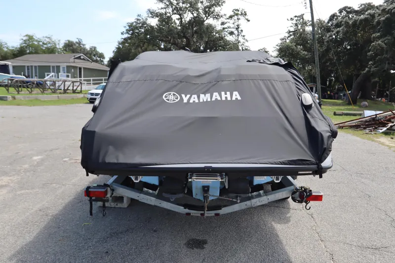 Slide: The Image of 2024 Yamaha SX220 boat covered on trailer, parked outdoors. - 39