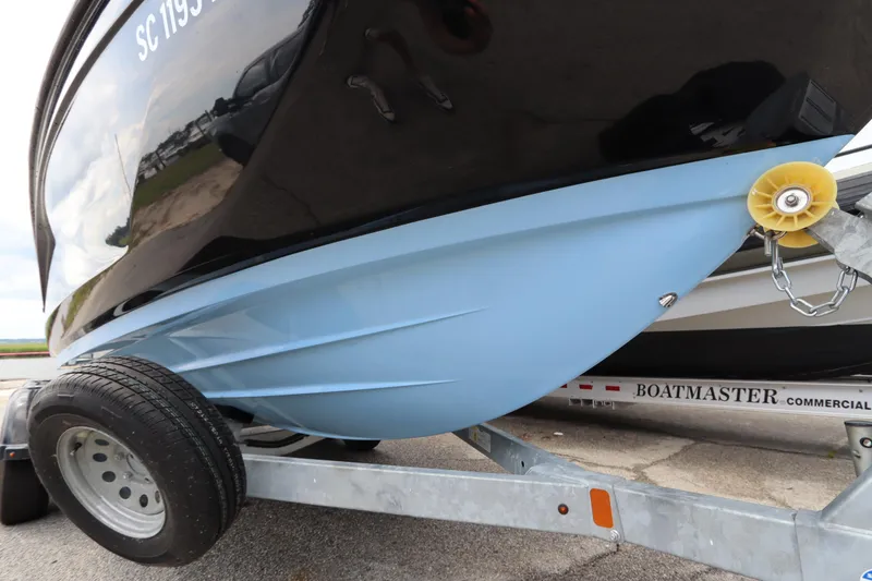 Slide: The Image of 2024 Yamaha Boats SX220 on trailer, showcasing sleek hull design. - 4