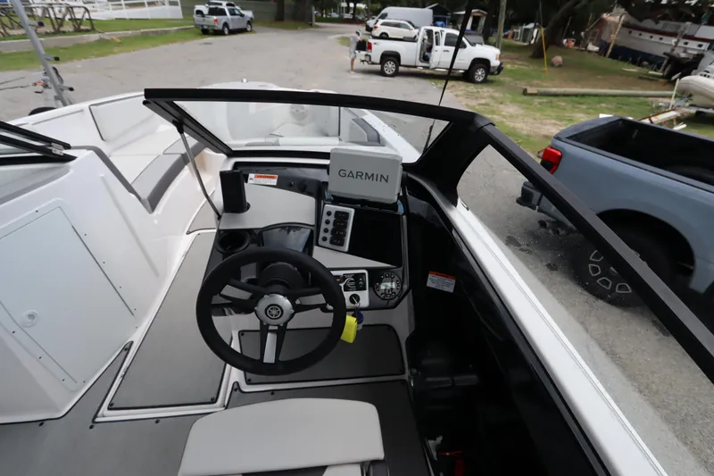 Slide: The Image of 2024 Yamaha Boats SX220 cockpit with Garmin navigation system, steering wheel, and dashboard controls. - 9
