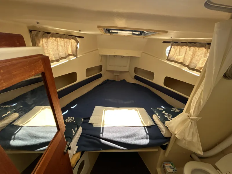 Slide: The Image of 2005 Rosborough RF-246 Custom Wheelhouse cabin interior with bed and curtains. - 4
