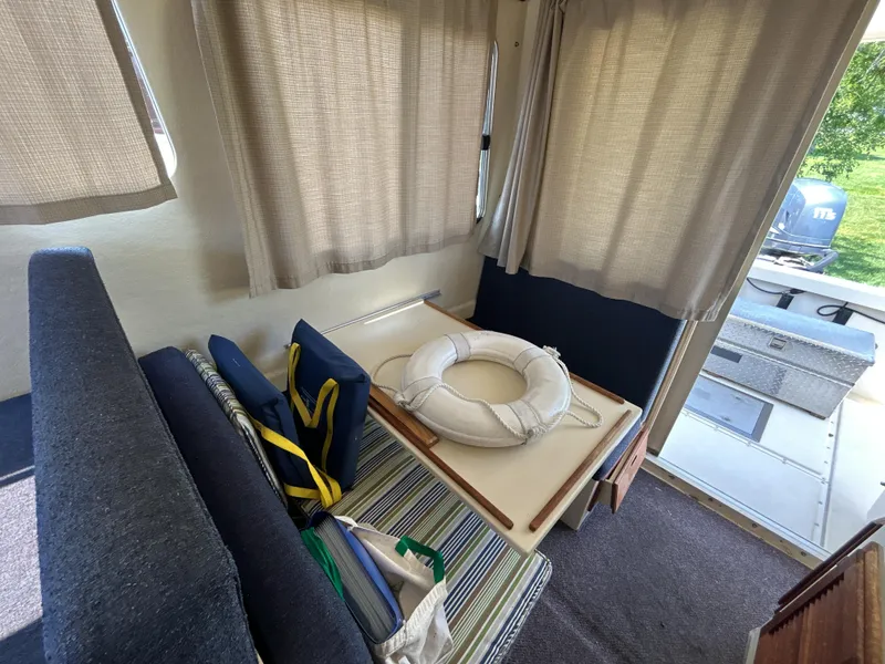 Slide: The Image of Interior of 2005 Rosborough RF-246 boat with seating, life preserver, and curtains. - 5