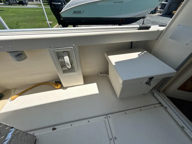 Slide: The Image of 2005 Rosborough RF-246 Custom Wheelhouse interior with storage box and electrical outlet. - 8