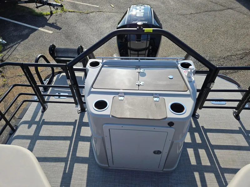 Slide: The Image of 2026 Starcraft CX23RL boat deck with storage and cup holders, featuring a Mercury outboard motor. - 10