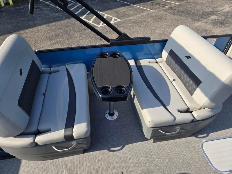 Slide: The Image of 2026 Starcraft CX23RL boat interior with gray seating and central table. - 11