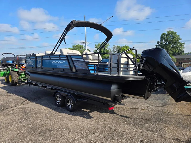 Slide: The Image of 2026 Starcraft CX23RL pontoon boat with Mercury outboard motor on a trailer. - 3