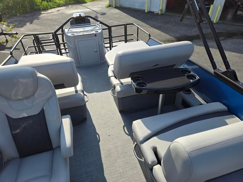 Slide: The Image of 2026 Starcraft CX23RL boat interior with plush seating and a central table. - 6