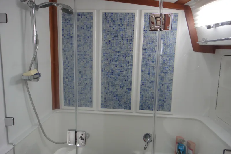 Slide: The Image of 2018 Sabre 48 Salon Express interior with storage drawers and stainless steel fridge. - 21