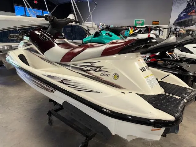 Slide: The Image of 2000 Yamaha WaveRunner XL 800 jet ski in showroom, featuring sleek design and maroon accents. - 4