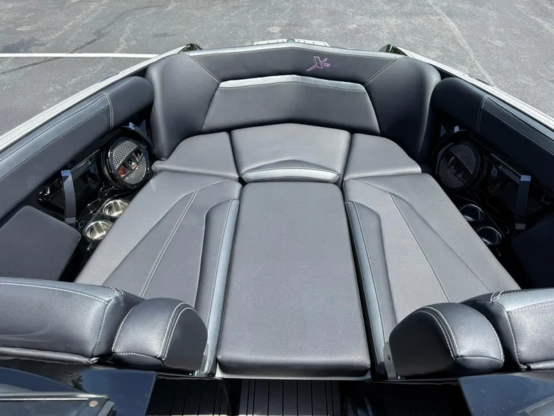 Slide: The Image of 2023 MasterCraft XStar S Piranha interior with luxurious seating and cup holders. - 11