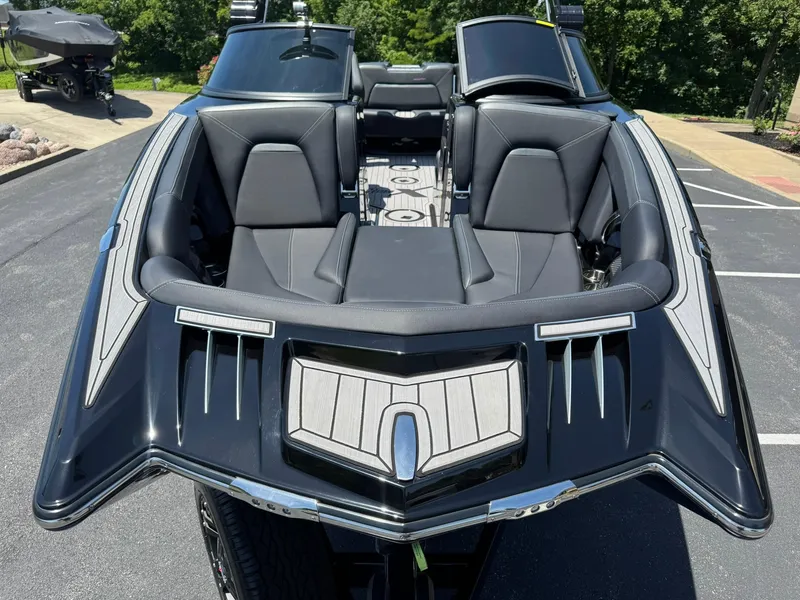 Slide: The Image of 2023 MasterCraft XStar S Piranha boat with sleek black design and luxurious seating. - 12