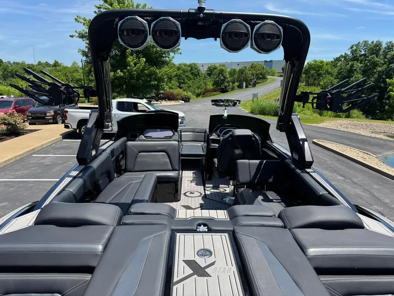 Slide: The Image of 2023 MasterCraft XStar S Piranha boat interior with sleek seating and advanced audio system. - 13
