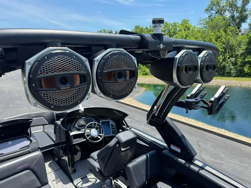 Slide: The Image of 2023 MasterCraft XStar S Piranha boat with premium audio speakers and sleek interior design. - 14