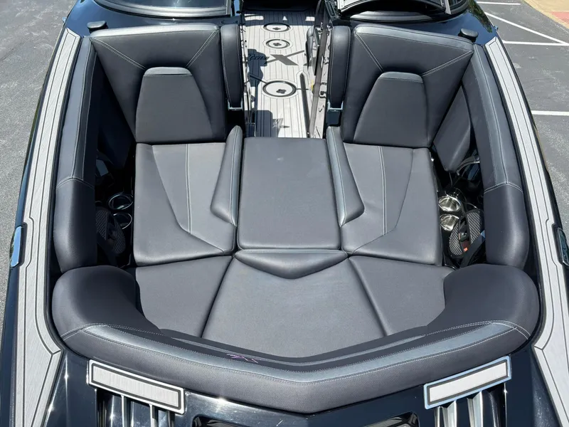Slide: The Image of 2023 MasterCraft XStar S Piranha boat interior with luxurious black seating. - 15