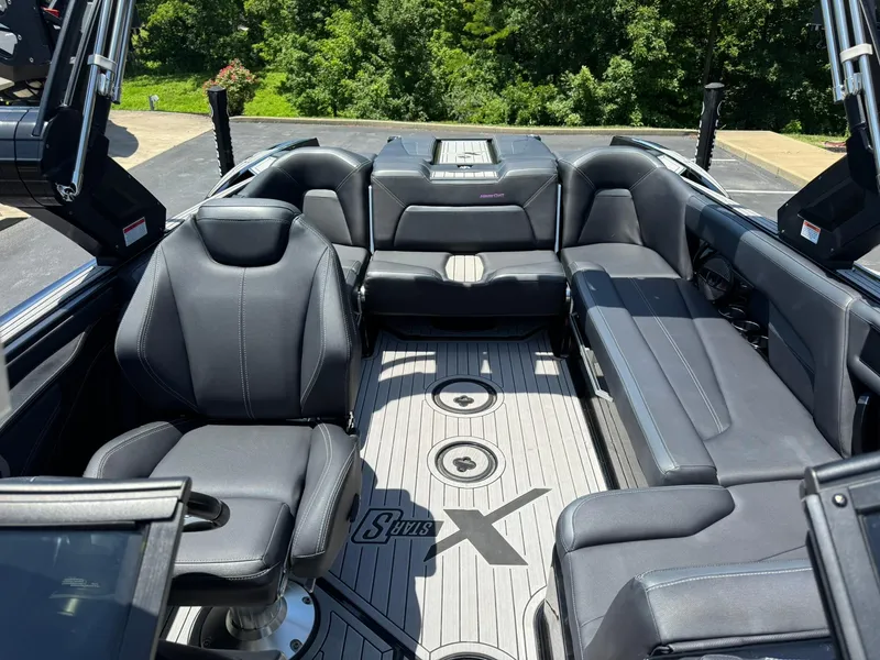 Slide: The Image of 2023 MasterCraft XStar S Piranha interior with black seating and sleek design. - 16