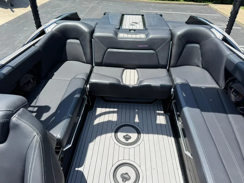 Slide: The Image of 2023 MasterCraft XStar S Piranha interior with sleek black seating and modern design. - 17