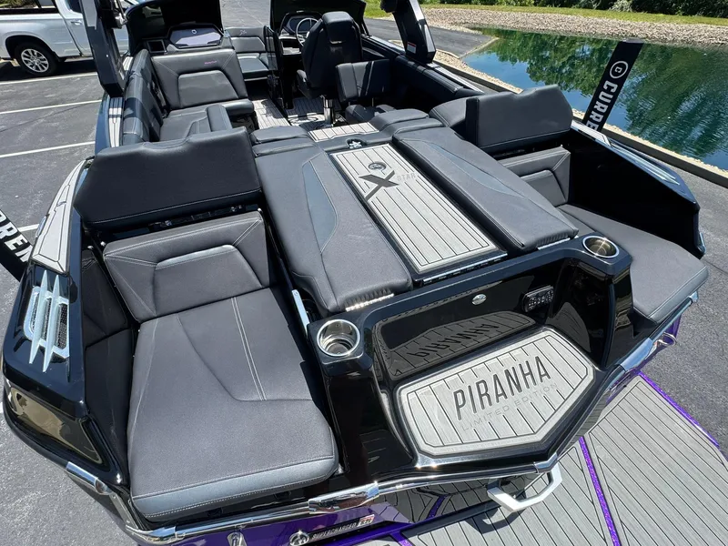 Slide: The Image of 2023 MasterCraft XStar S Piranha boat interior with luxurious seating and sleek design. - 20