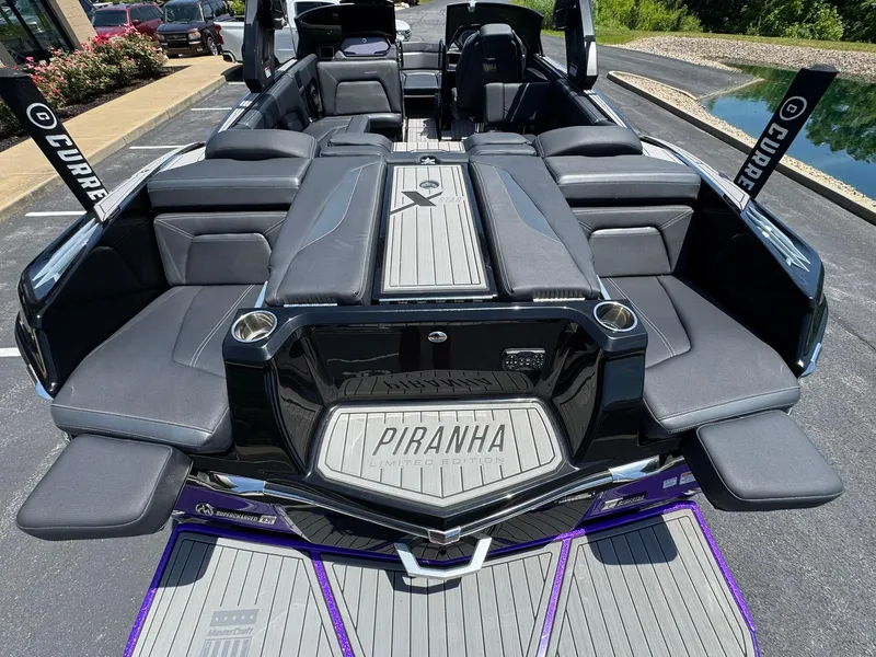 Slide: The Image of 2023 MasterCraft XStar S Piranha boat interior with luxurious seating and sleek design. - 21