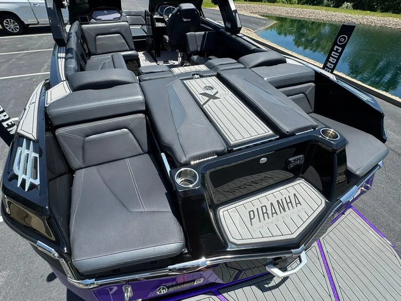 Slide: The Image of 2023 MasterCraft XStar S Piranha boat interior with luxurious seating and sleek design. - 4
