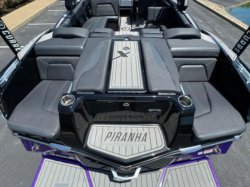 Slide: The Image of 2023 MasterCraft XStar S Piranha boat interior with luxurious seating and custom flooring. - 5