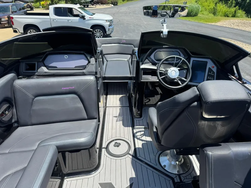 Slide: The Image of 2023 MasterCraft XStar S Piranha boat interior with sleek seating and modern dashboard. - 7