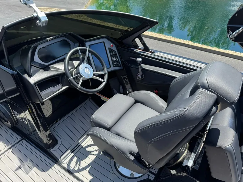 Slide: The Image of 2023 MasterCraft XStar S Piranha boat interior with sleek steering and modern dashboard. - 8