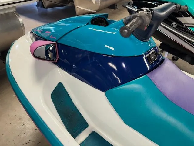 Slide: The Image of 1995 Yamaha WaveRunner Wave Venture in vibrant teal and purple, showcasing sleek design and handlebars. - 10