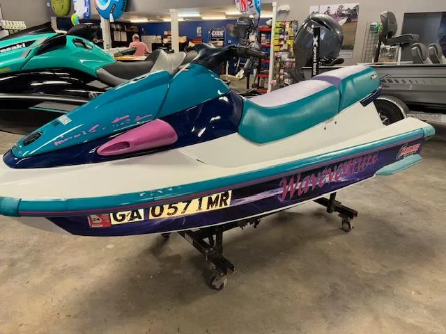 Slide: The Image of 1995 Yamaha WaveRunner Wave Venture jet ski in showroom, teal and purple design. - 3
