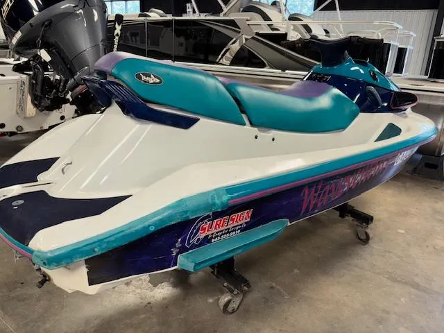 Slide: The Image of 1995 Yamaha WaveRunner Wave Venture jet ski in a showroom, teal and purple design. - 5