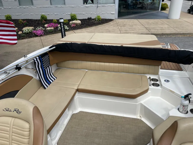 Slide: The Image of 2018 Sea Ray SPX 210 boat interior with tan seating and American flag. - 6