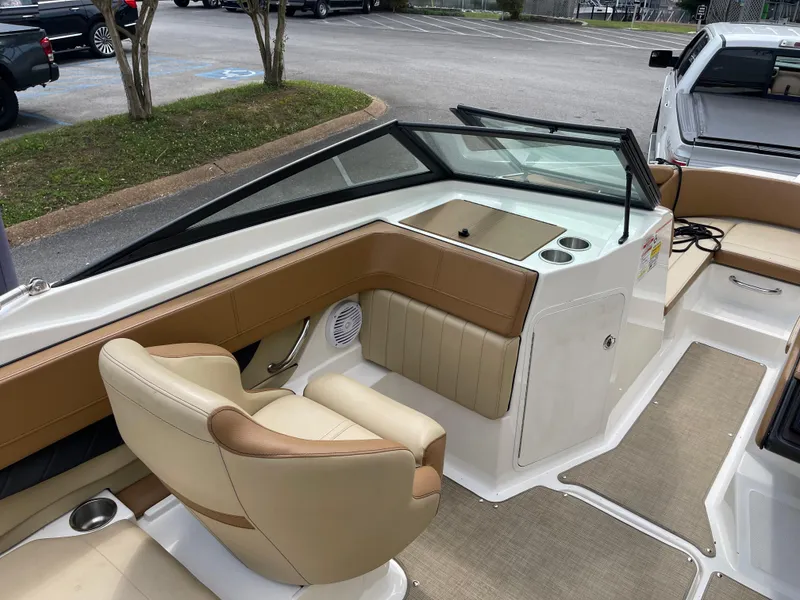 Slide: The Image of 2018 Sea Ray SPX 210 boat interior with tan seating and modern design. - 8