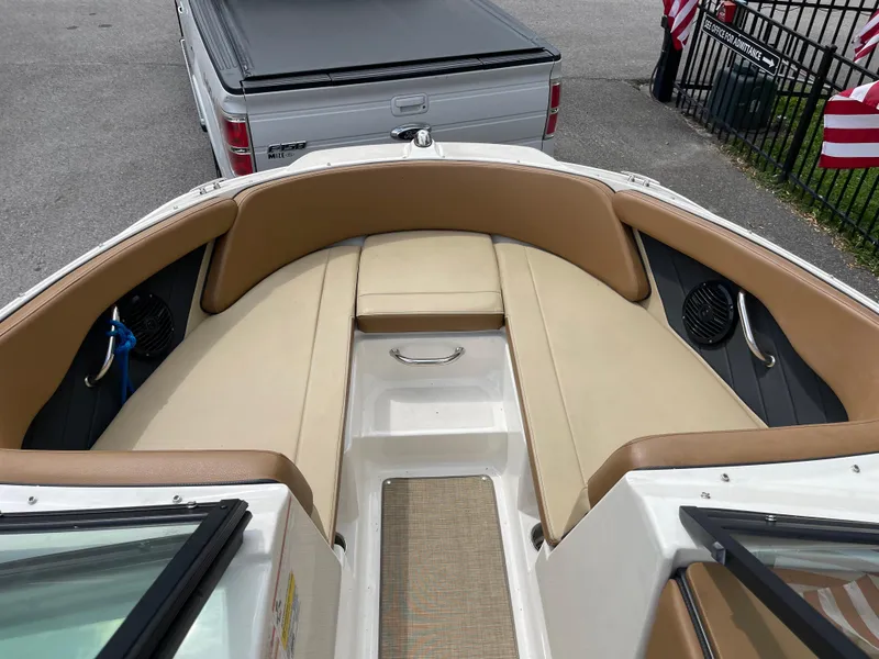 Slide: The Image of 2018 Sea Ray SPX 210 boat interior with tan seating and speakers. - 9