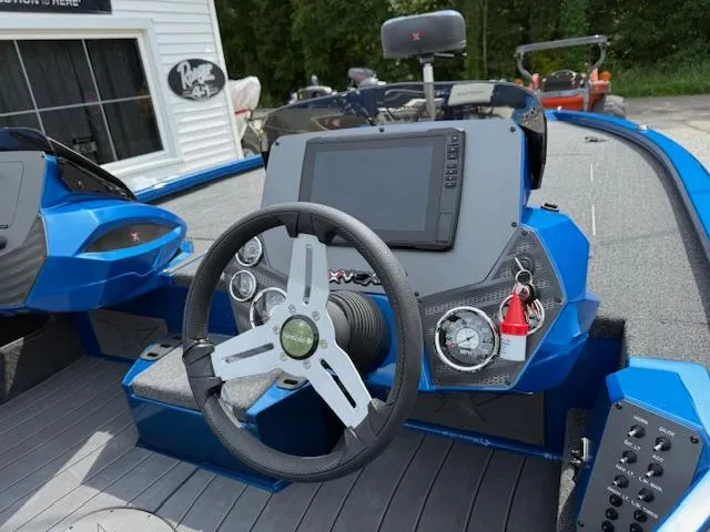 Slide: The Image of 2026 Vexus 2085s boat dashboard with steering wheel, touchscreen display, and control panel. - 5