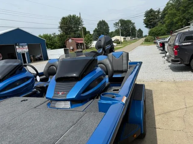 Slide: The Image of 2026 Vexus 2085s boat in blue, parked outdoors on a sunny day. - 9