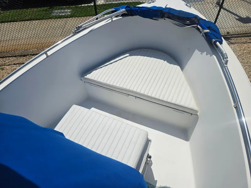 Slide: The Image of 1994 Celebrity Fish Hawk 18 boat interior with white seating and blue cover. - 2
