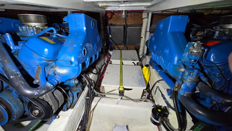 Slide: The Image of Engine room of 1979 Chris-Craft 360 Commander with blue engines. - 17