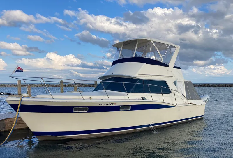 Slide: The Image of 1979 Chris-Craft 360 Commander yacht docked under cloudy sky. - 2