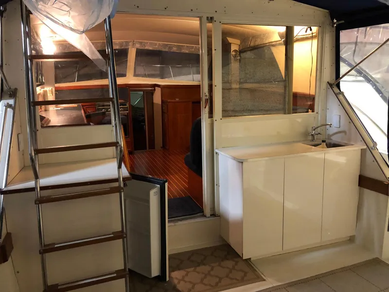 Slide: The Image of Interior of a 1979 Chris-Craft 360 Commander yacht with stairs and kitchenette. - 24