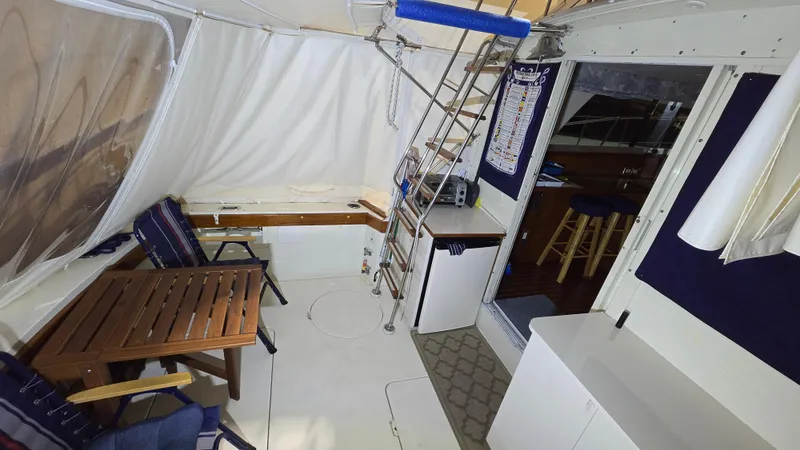 Slide: The Image of Interior of a 1979 Chris-Craft 360 Commander with seating area and ladder. - 25
