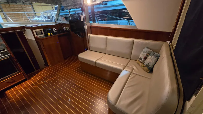 Slide: The Image of 1979 Chris-Craft 360 Commander interior with leather sofa and wooden flooring. - 6