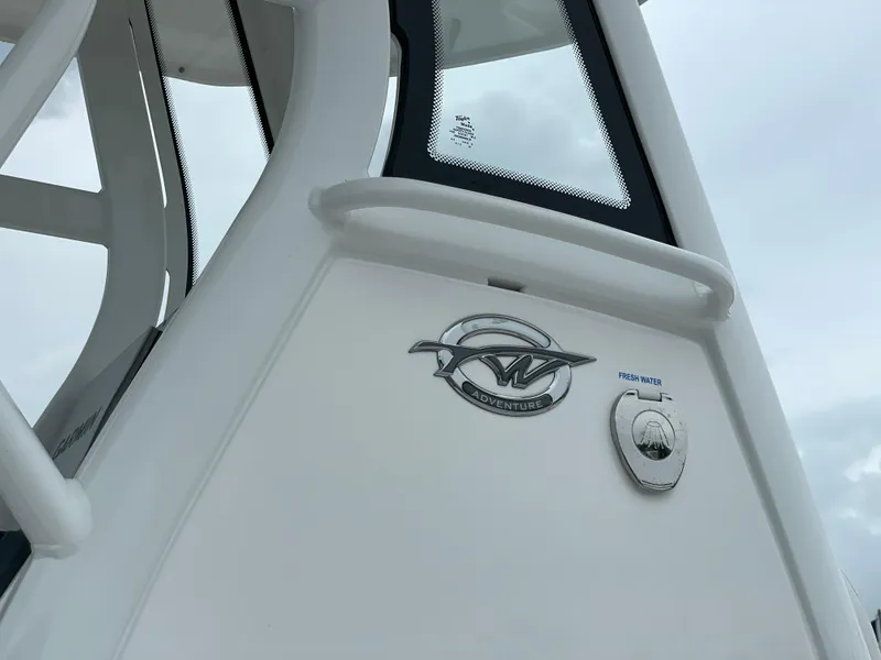 Slide: The Image of 2026 Tidewater 232 CC Adventure boat detail with logo and fresh water access. - 10