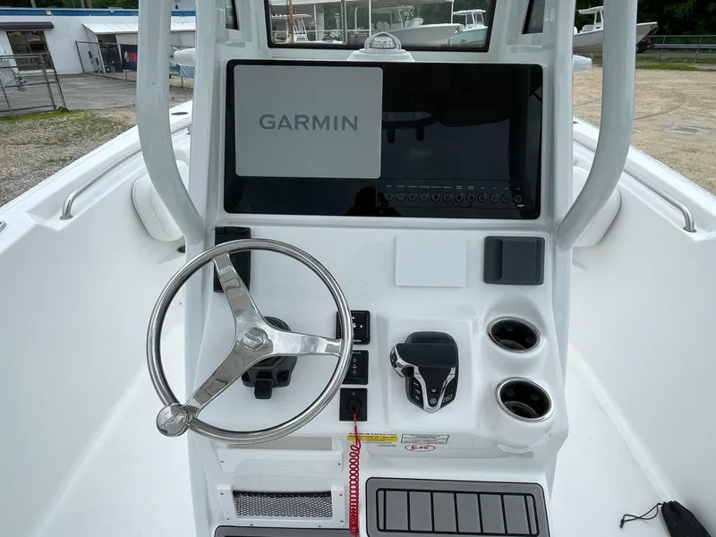 Slide: The Image of 2026 Tidewater 232 CC Adventure boat console with Garmin display and steering wheel. - 14