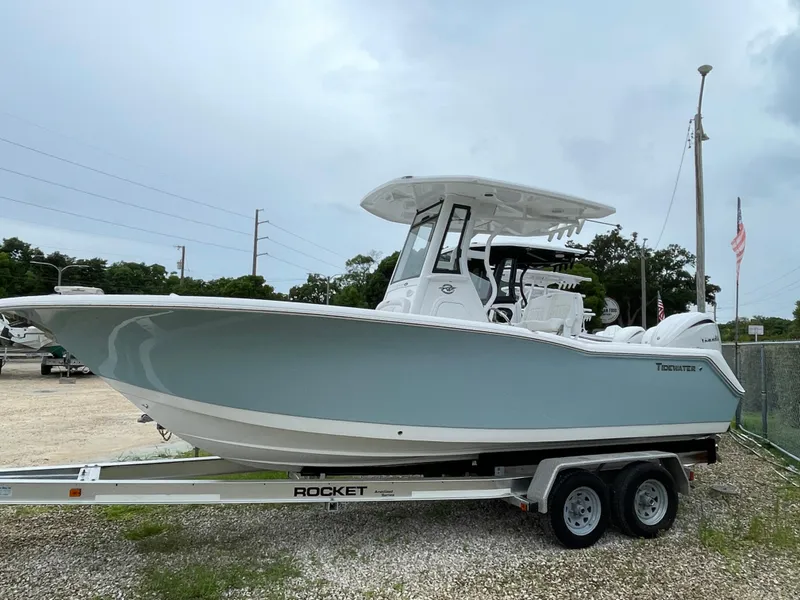 Slide: The Image of 2026 Tidewater 232 CC Adventure boat on trailer, displayed outdoors. - 2