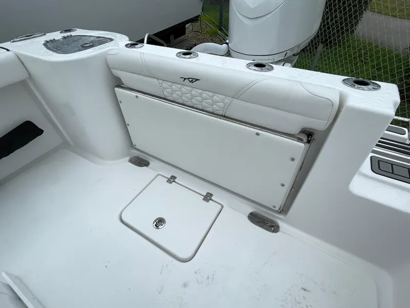 Slide: The Image of 2026 Tidewater 232 CC Adventure boat interior with foldable seat and storage compartment. - 21