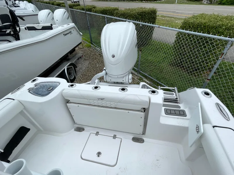 Slide: The Image of 2026 Tidewater 232 CC Adventure boat, rear view with outboard motor and seating area. - 25