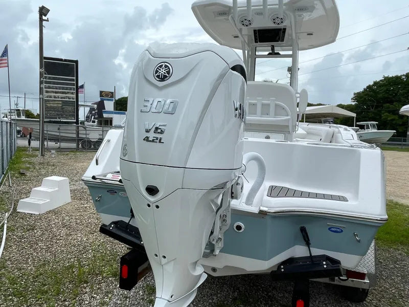 Slide: The Image of 2026 Tidewater 232 CC Adventure boat with Yamaha 300 V6 engine displayed outdoors. - 27