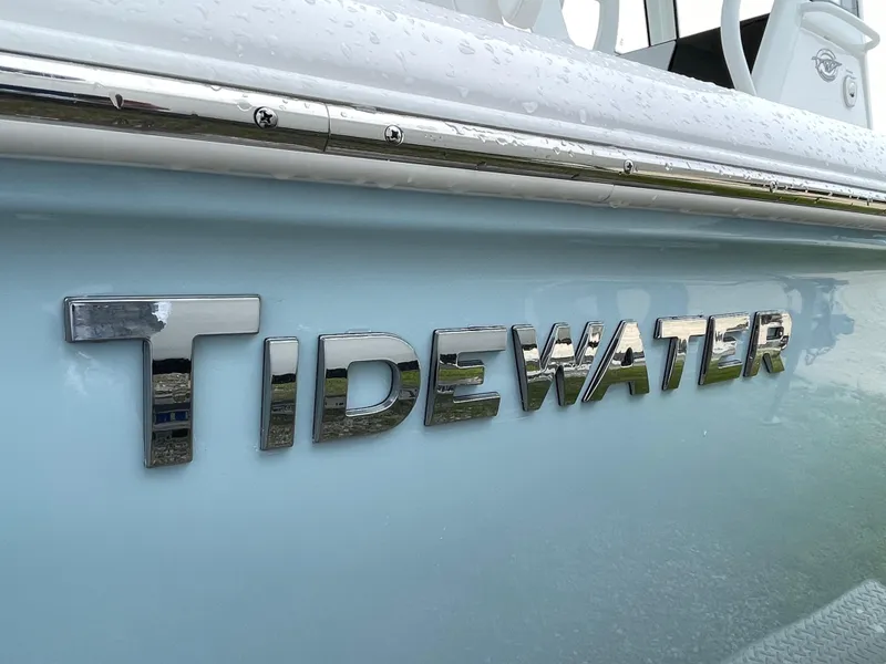 Slide: The Image of Chrome "Tidewater" logo on 2026 Tidewater 232 CC Adventure boat hull. - 4