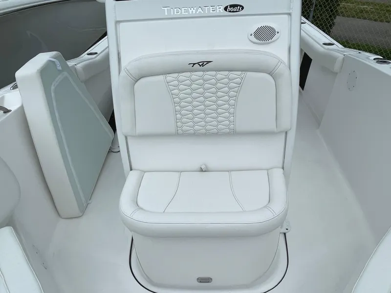 Slide: The Image of 2026 Tidewater 232 CC Adventure boat seat with white upholstery and speaker. - 8