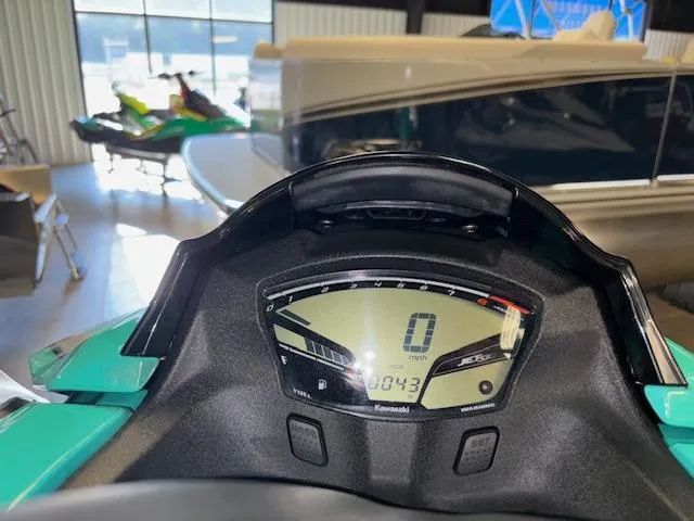Slide: The Image of Dashboard of a 2021 Kawasaki Ultra LX jet ski in a showroom setting. - 10