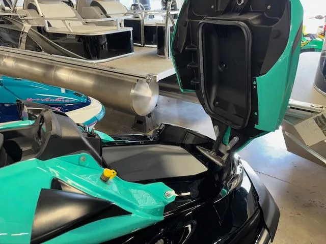 Slide: The Image of 2021 Kawasaki Ultra LX jet ski with open storage compartment in a showroom. - 11