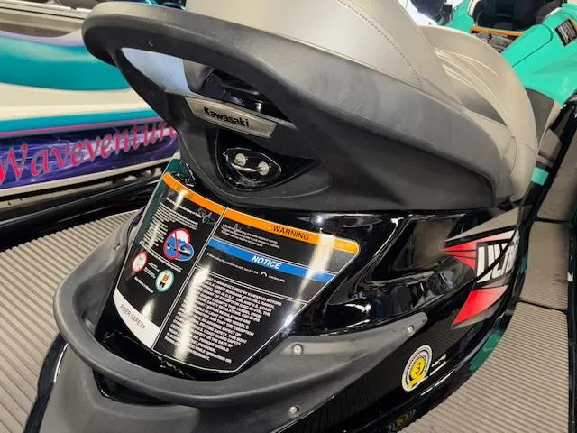 Slide: The Image of 2021 Kawasaki Ultra LX jet ski rear view with safety labels and branding. - 12